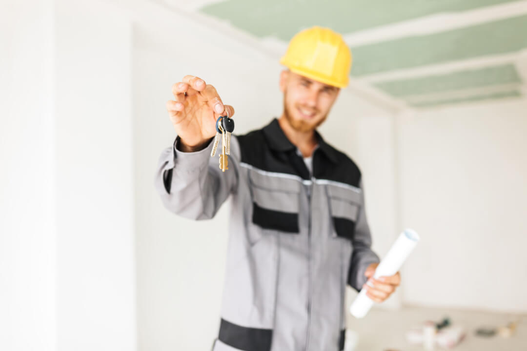 Close up photo of young engineer in work clothes and yellow hard